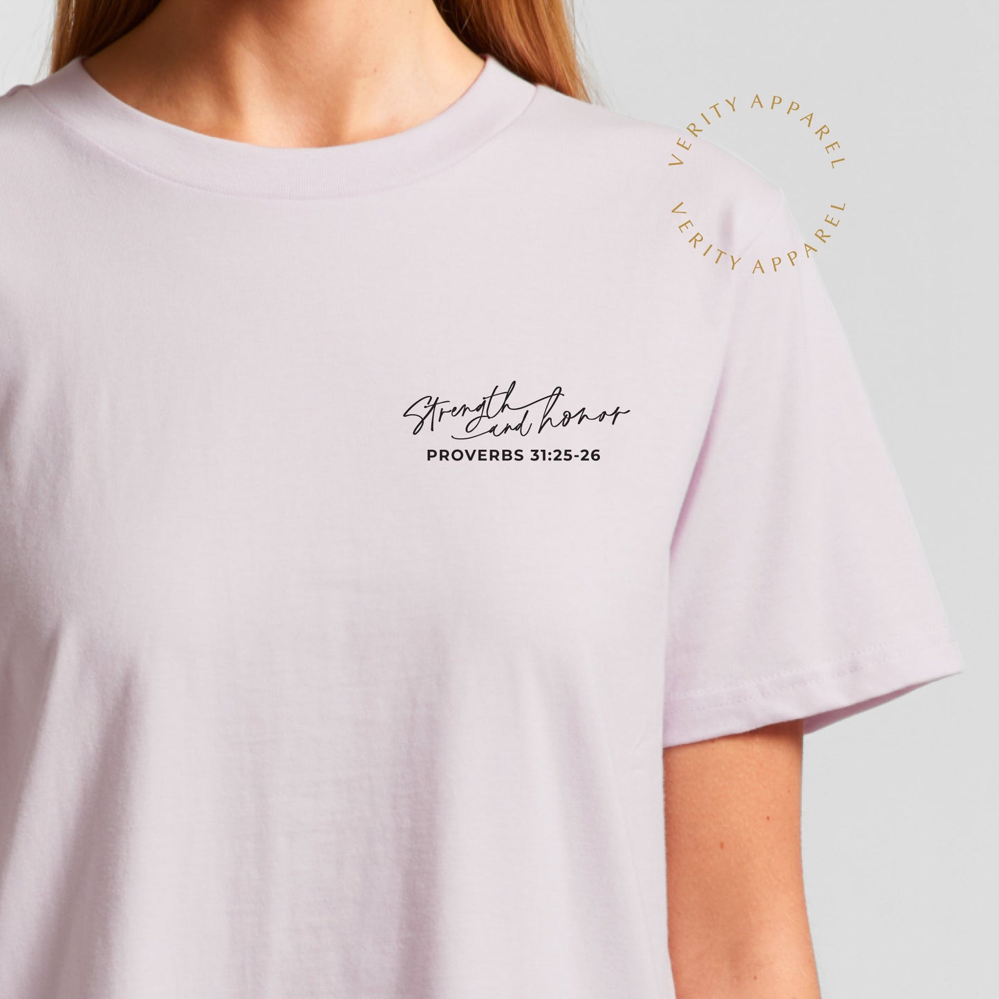 Front close up of a cotton christian t-shirt in orchid colour, features a left chest print with the words: strength and honour, Proverbs 31 :25-26 in a stylish script design.