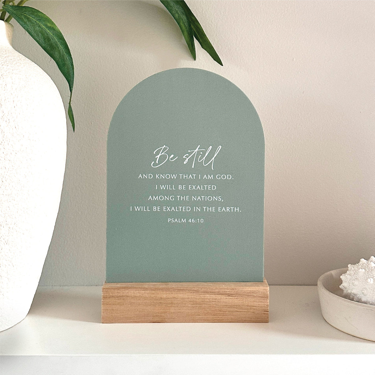 Be Still Psalm 46:10 Verse & Oak scripture stand with handcrafted Tasmanian oak base, styled on a white shelf with greenery.